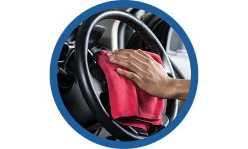 a person drying a steering wheel