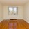 a room with a wood floor and a window